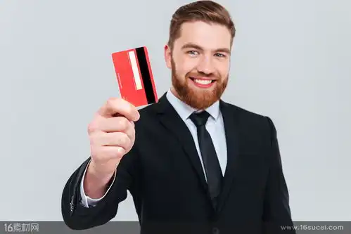 手拿红色信用卡的商务人士高清摄影图片